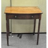 A Victorian mahogany side table with bow front and single drawer, on turned legs,