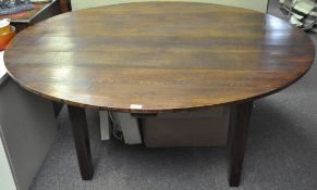 An early 20th century large circular dining table on tapered square legs,