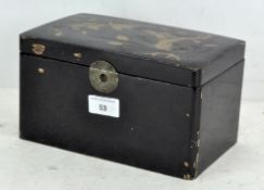 An Oriental black lacquered tea caddy, decorated with a snake, bird and blossoms, with brass clasp,