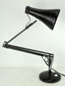 A Herbert Terry & Sons Ltd Anglepoise lamp, in black and mounted on a circular base,