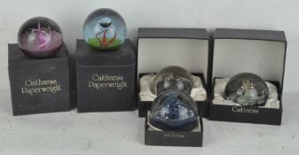 A selection of five limited edition Caithness glass paperweights, most in original boxes,