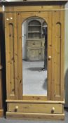 A modern pine two-door wardrobe, with lower drawer,