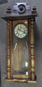 An Edwardian twin weight cased Vienna 'regulator' wall clock, complete with pediment,