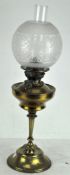 A Victorian oil lamp, with decorated glass shade, clear chimney and clear glass reservoir,