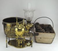 A group of brassware, including a kettle, jardiniere, trivet, oil lamp,