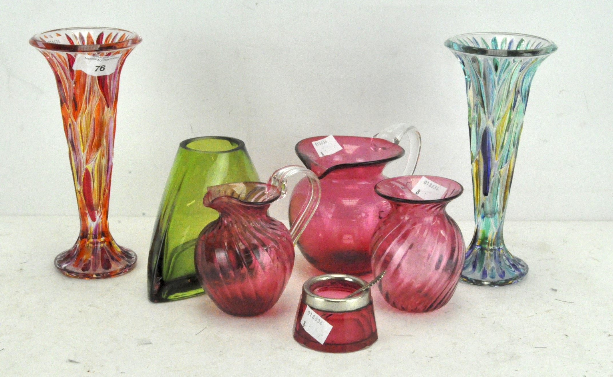 A selection of coloured glassware, including two multi coloured cut glass vases,