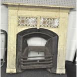An Edwardian cast iron fire surround, grate and mantel, the surround and mantel painted cream,