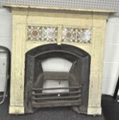 An Edwardian cast iron fire surround, grate and mantel, the surround and mantel painted cream,