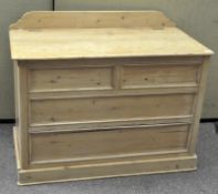 A large pine trunk with gallery back, hinged lid and fixed 'drawer' fronts,