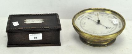 A carved wooden box with a silver engraved plaque mounted on the lid,