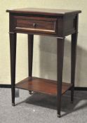 A 20th Century mahogany cabinet, containing a single drawer, on tapered supports,