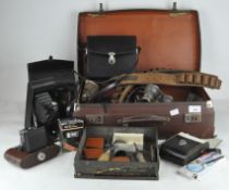 A vintage Gladiator leather bound suitcase containing two pairs of binoculars, opera glasses,