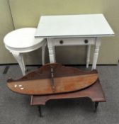 A white painted wooden side table, with a single drawer and glass top, raised on turned supports,