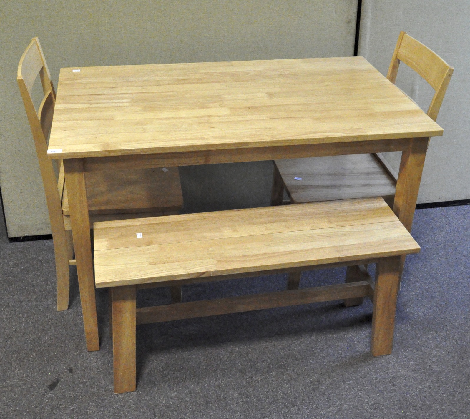 A modern dining table with two chairs and a bench,