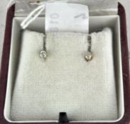 A boxed pair of 9ct gold diamond solitaire stud earrings