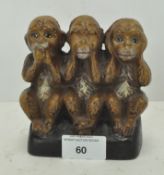 A novelty metal money bank modelled as a 'Hear-No, See-No, Speak-No Evil' monkey figurine