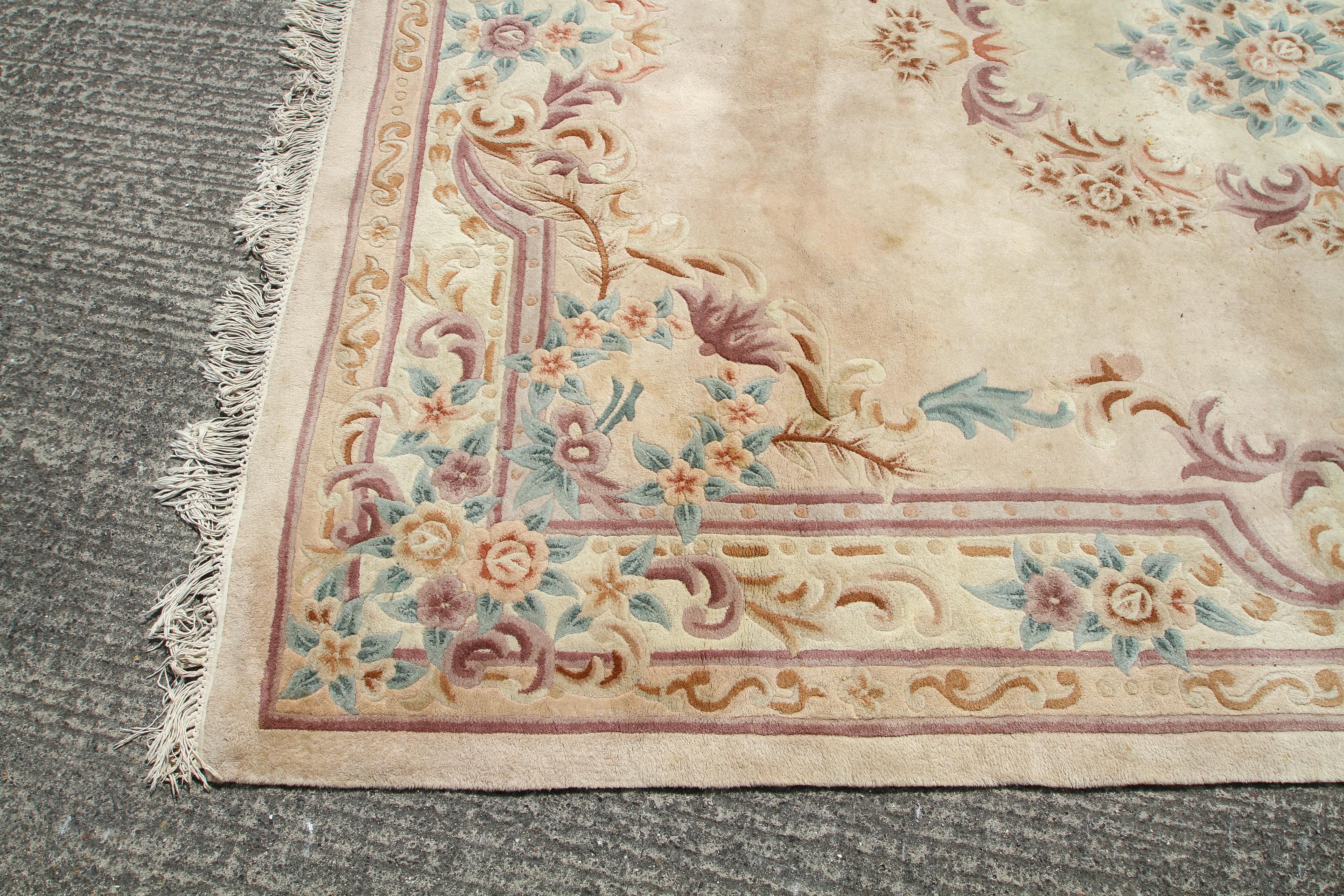 A large 20th century rug, decorated with floral motifs and a central medallion on a cream ground, - Image 2 of 3