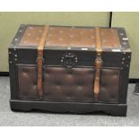 A vintage button embossed wooden trunk with straps and brass fittings,