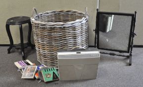 A large two-handled wicker log basket containing a Fidelity radio,