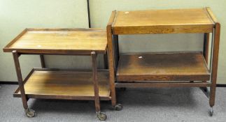 Two wooden tea trolleys, both with shelves and on wheels,