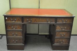 A 20th century oak leather topped twin pedestal desk,