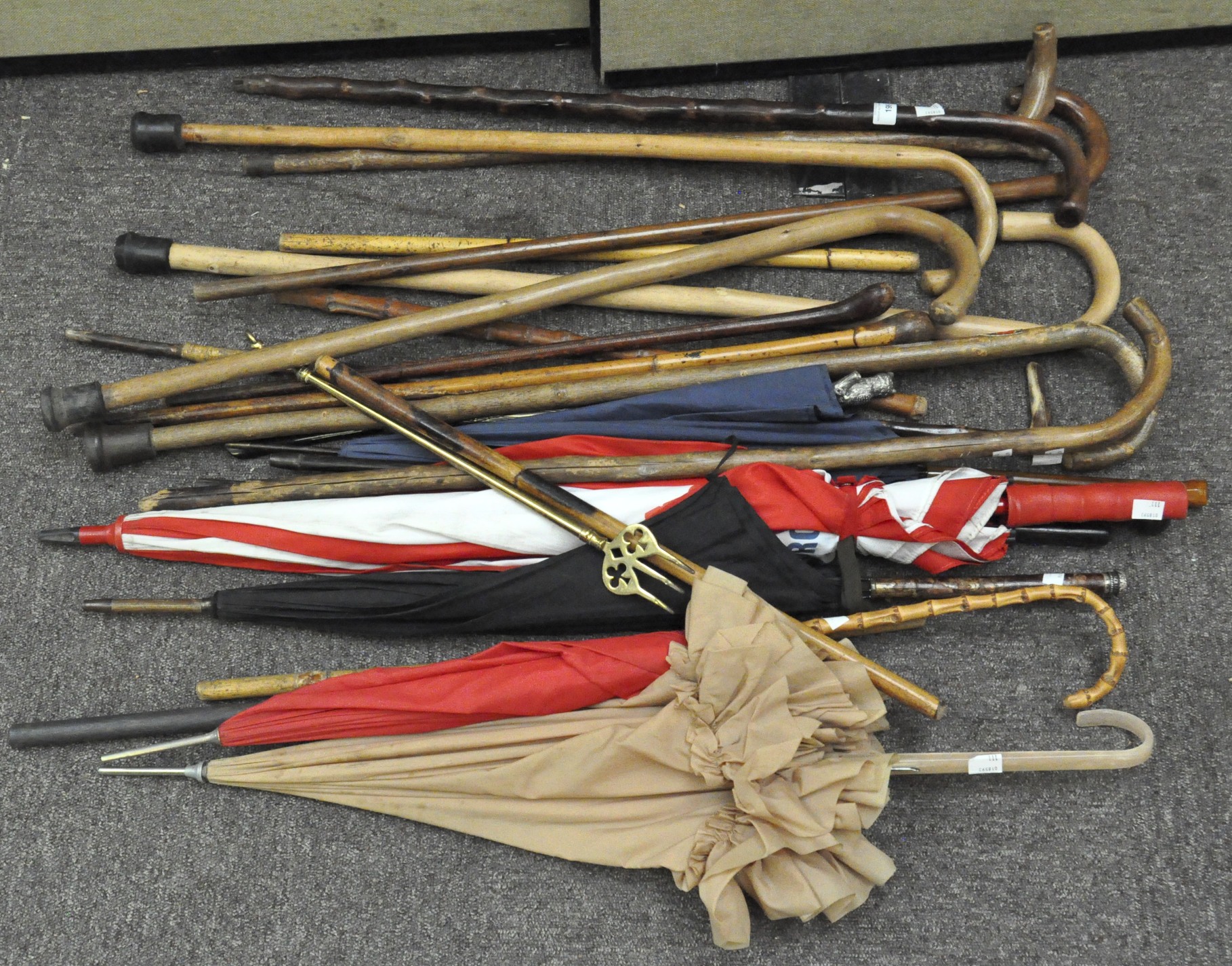 A collection of 20th century walking sticks and parasols,