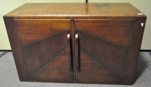 A 1930's Art Deco oak side cabinet, the twin doors opening to reveal three shelves,