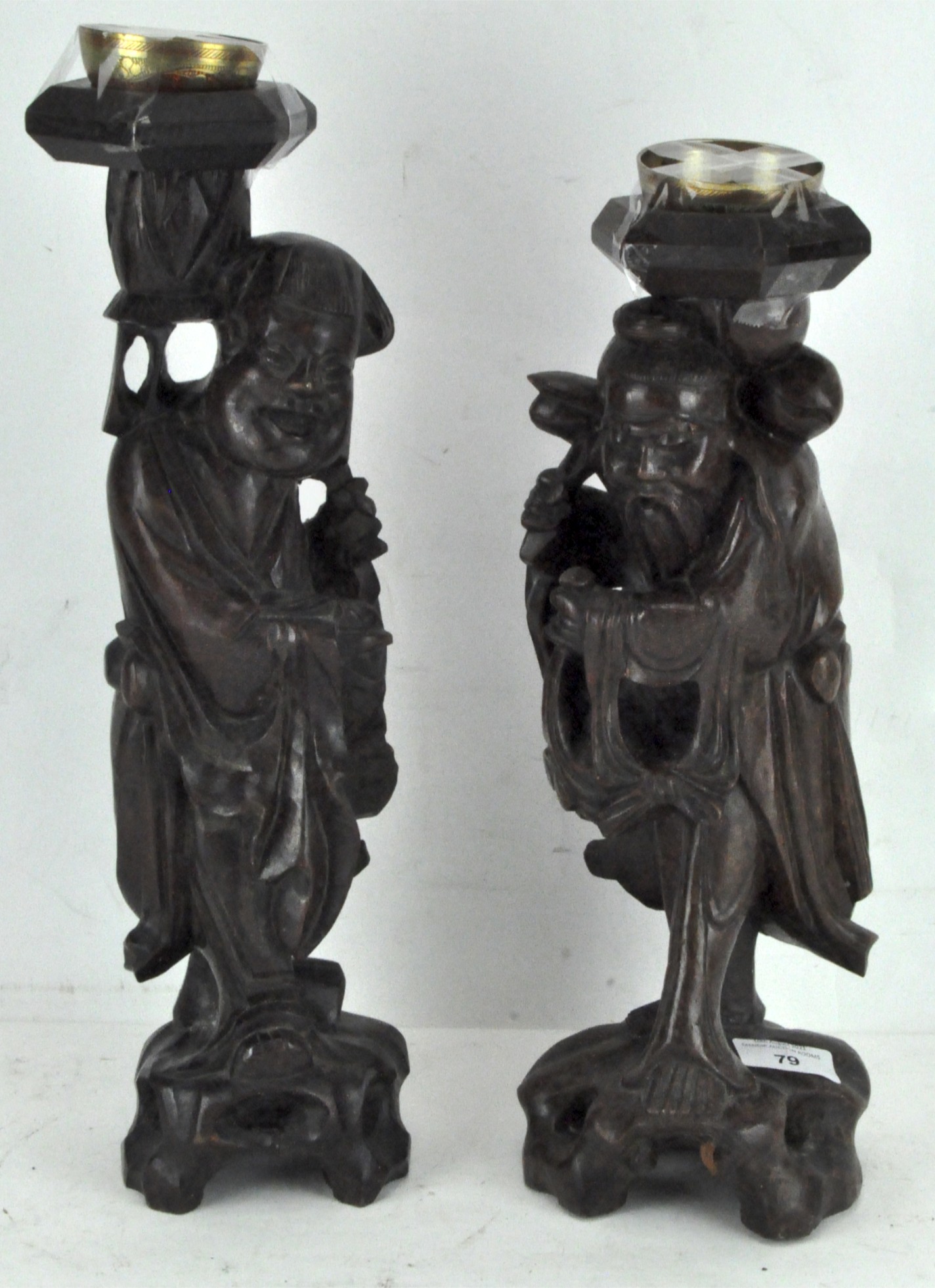 A pair of carved wooden Chinese incense holders, each modelled as robed figures,