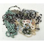 A collection of beaded necklaces of various colours,