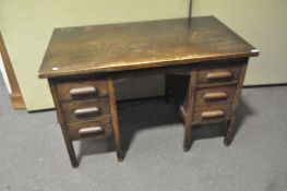 A 1930's twin pedestal oak desk, with three drawers either side,