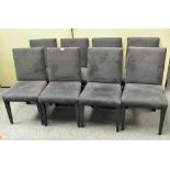 Eight contemporary dining chairs upholstered in black suedette, on tapering square legs,