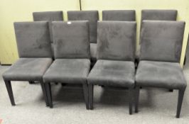 Eight contemporary dining chairs upholstered in black suedette, on tapering square legs,