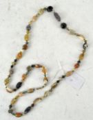A mixed hardstone necklace, each stone segregated by small gold coloured beads,