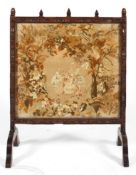 A 19th century oak fire screen with tapestry insert,