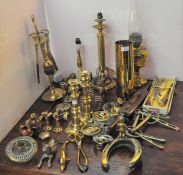 A large collection of brassware including a pair of brass candlesticks,