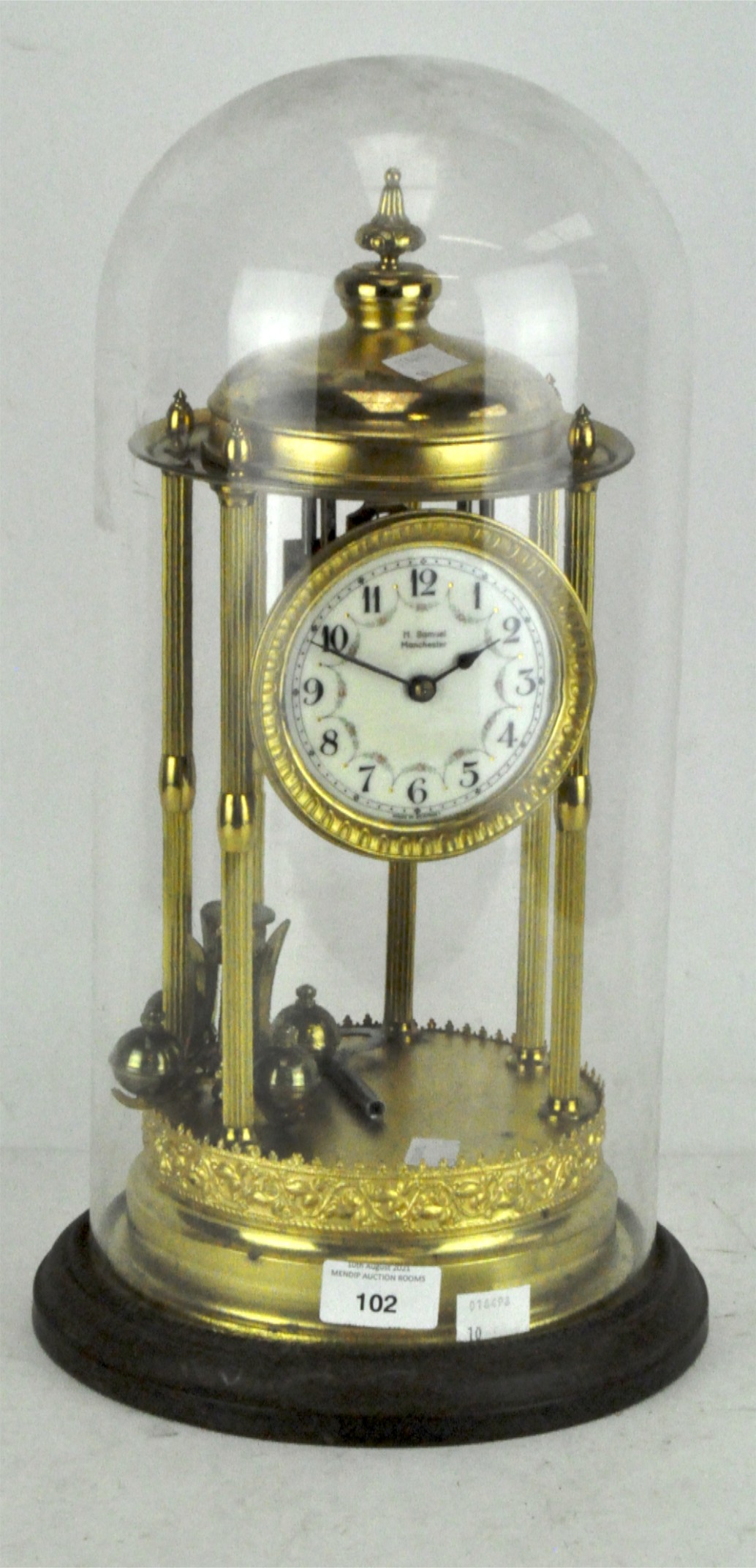 A 20th century brass torsion four-ball pendulum mantel clock, the face with Arabic numerals,