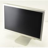 An Apple 21" computer screen with cable on a stand,