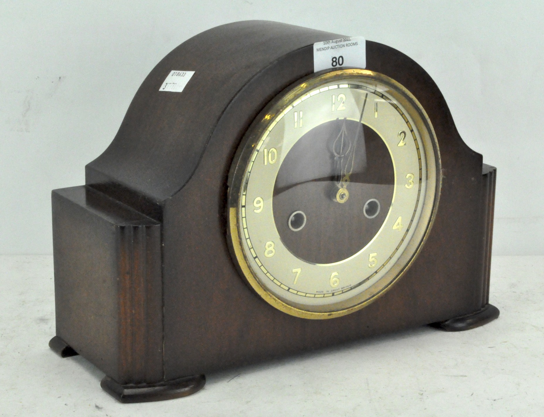 A vintage mantel clock, cream dial with gilt Arabic numerals, in a wooden case,