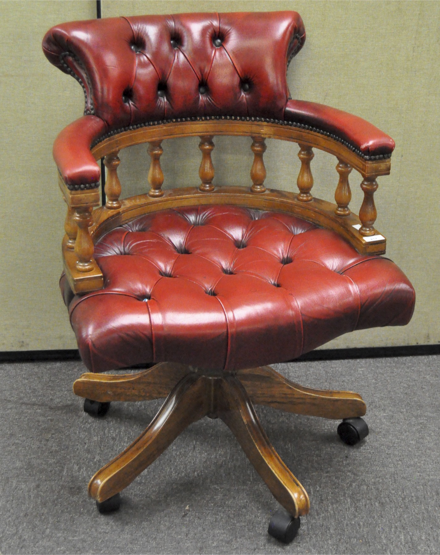 A 20th century antique style red leather Chesterfield Captain's mahogany framed swivel chair