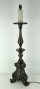 A 20th century brass electric table lamp, with scrolling details, supported on three cabriole feet,