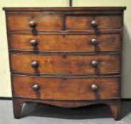 A mahogany bow front chest of drawers, two short over three long drawers, turned knob handles,