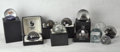A collection of mostly Selkirk glass paperweights, some signed and limited edition,