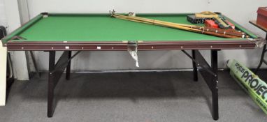 A Jacques folding pool table, with two sets of balls, a triangle, scoreboard and seven cues,
