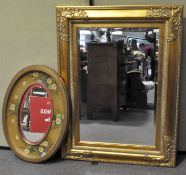 Large gilt framed wall mirror with scrolling motif details,