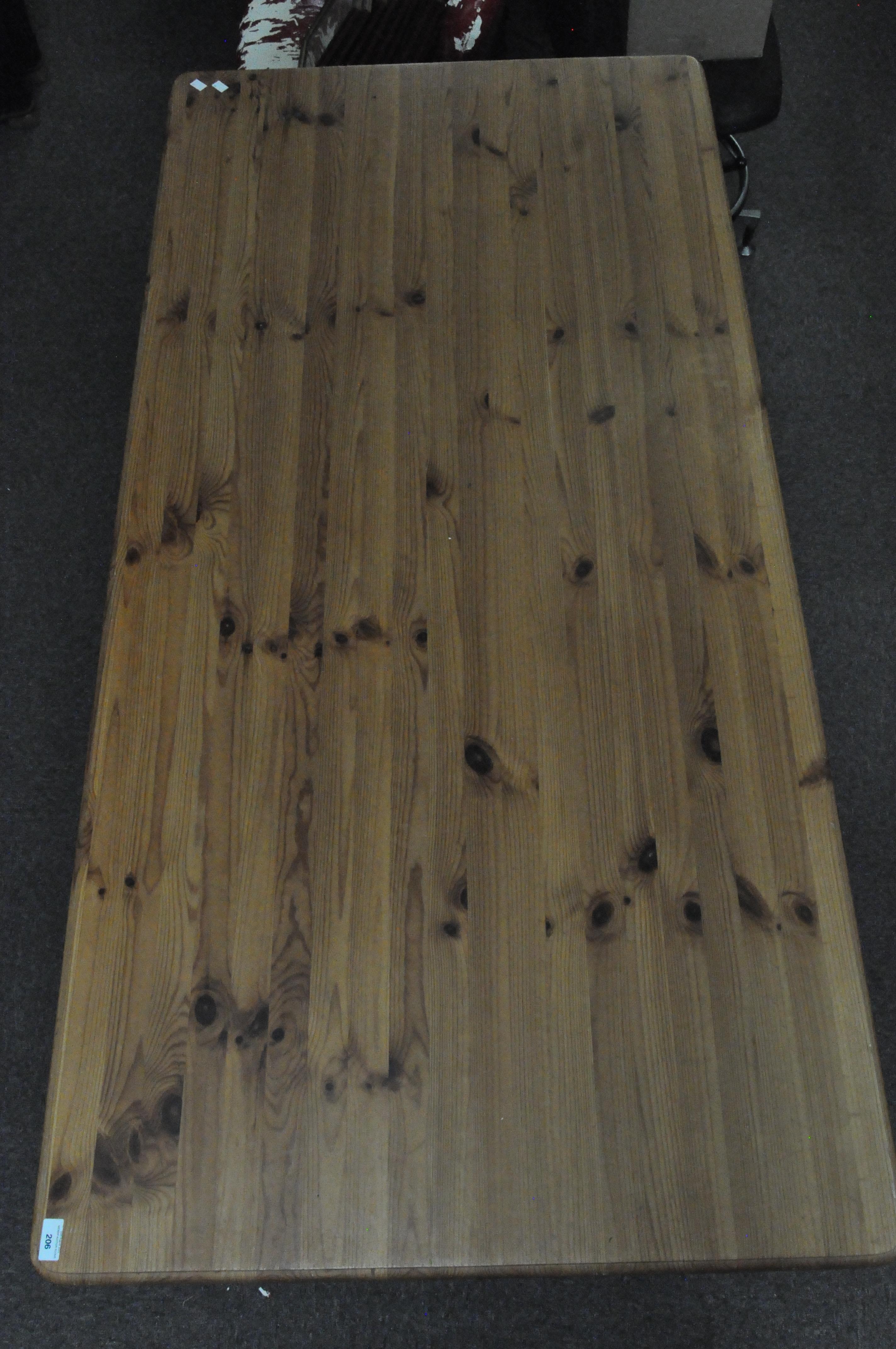 A pine kitchen table with turned legs,