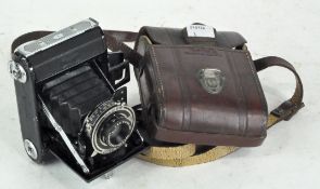 A vintage Zeiss Ikon camera and leather Kodak case