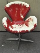 A 'Swan' design swivel chair with red leather upholstery, on castors,