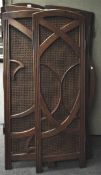 A six panel teak and cane screen with fluted supports flanking the curved wood pattern,
