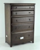 A miniature oak chest of drawers, early 20th century, with 5 drawers and metal ring handles,