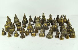 A collection of fifty vintage brass bells, cast as ladies in crinolines and other examples